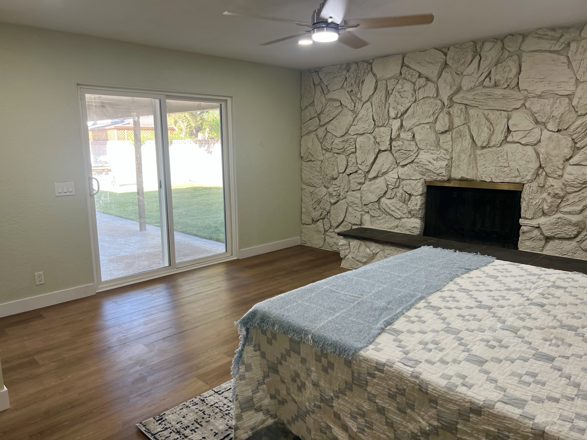 Secondary bedroom with stone fireplace